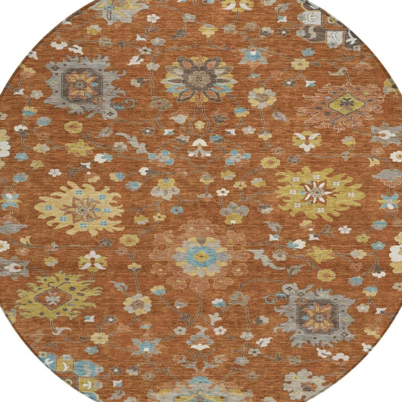 Overhead view of round rust-brown rug with multicolor floral medallions and scrollwork