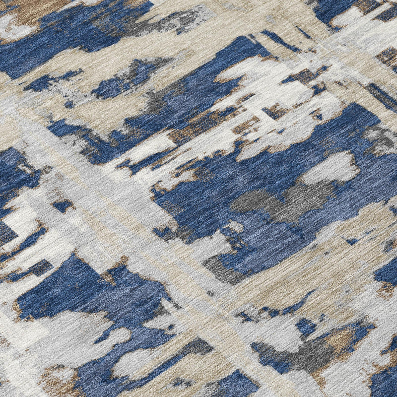 Close-up of navy and blue abstract area rug with distressed cream texture