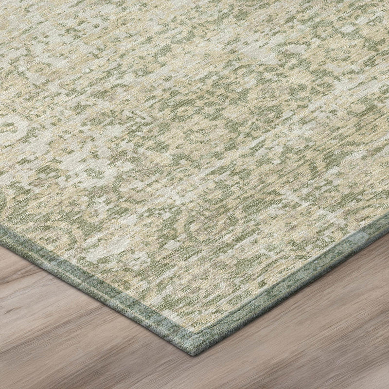 Abstract area rug with sage green and cream textured weave and visible border edge