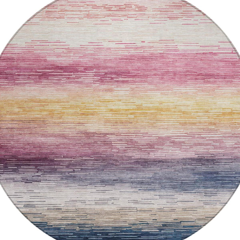 Round striped area rug with blush-pink, gold, and blue horizontal bands
