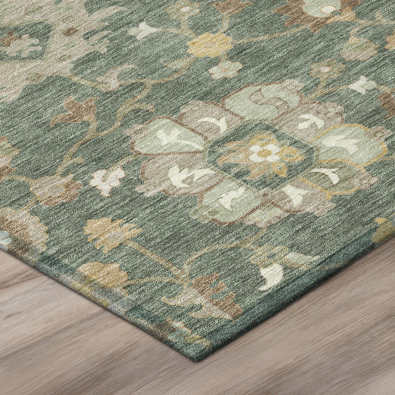 Corner detail of teal-green floral area rug with beige and gold motif accents