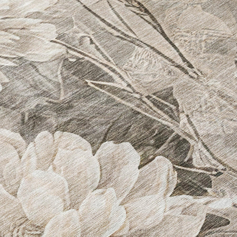 Fabric close-up of taupe and brown floral area rug with white blossoms and stems