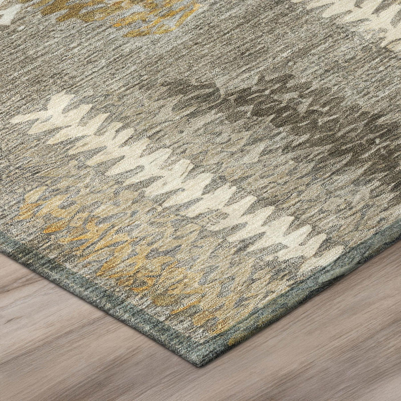Abstract area rug corner with flatweave texture, gray base with cream and gold accents