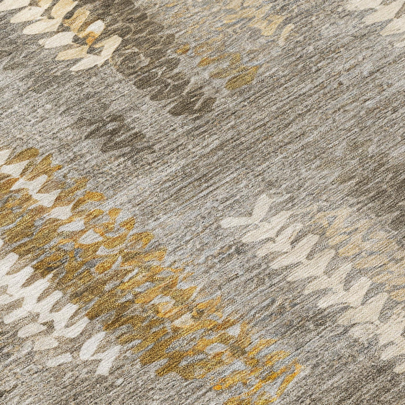 Textured abstract rug detail in gray pewter with gold and white chevron lines