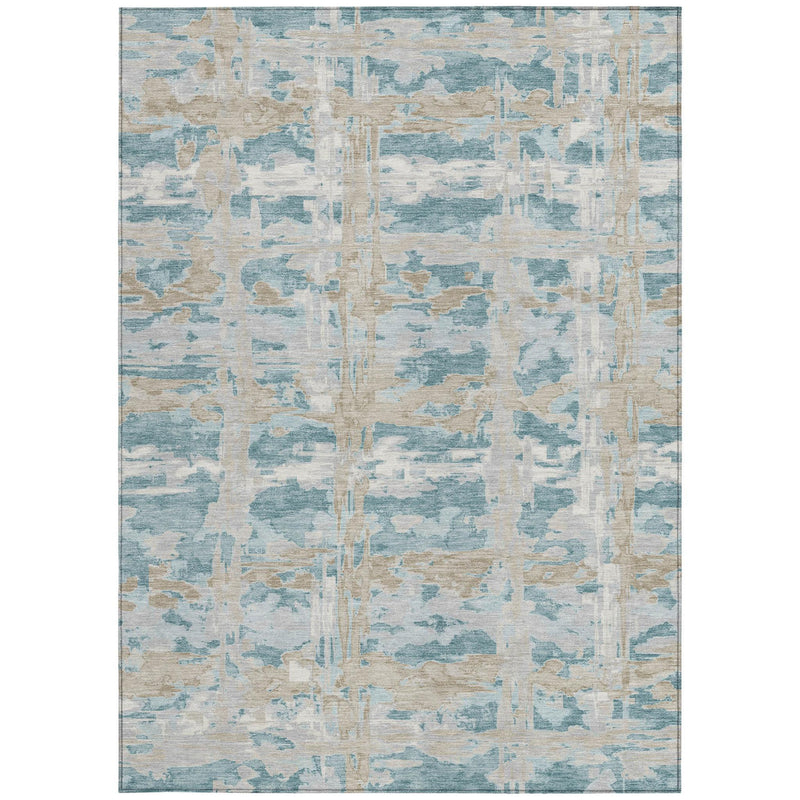Abstract indoor/outdoor area rug in teal blue, silver, and light beige with distressed lines