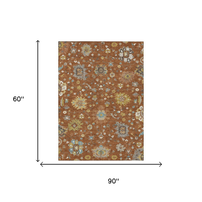 Brown floral area rug with orange-brown base and scattered blue and cream medallions