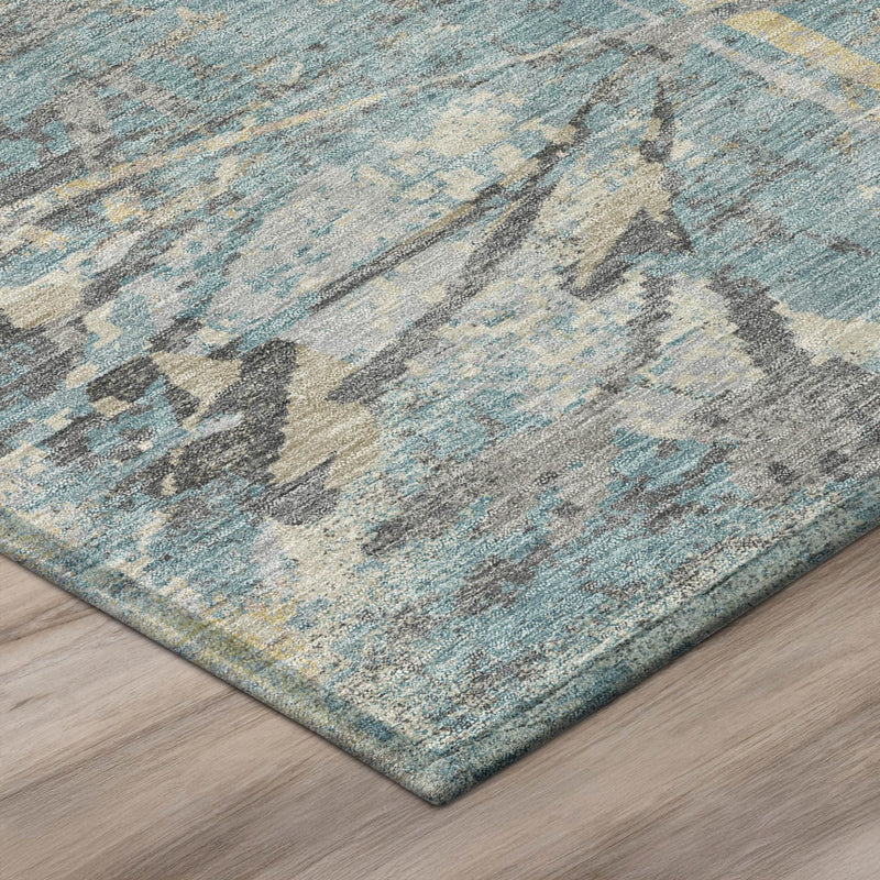 Teal and silver floral patterned area rug corner with textured low pile