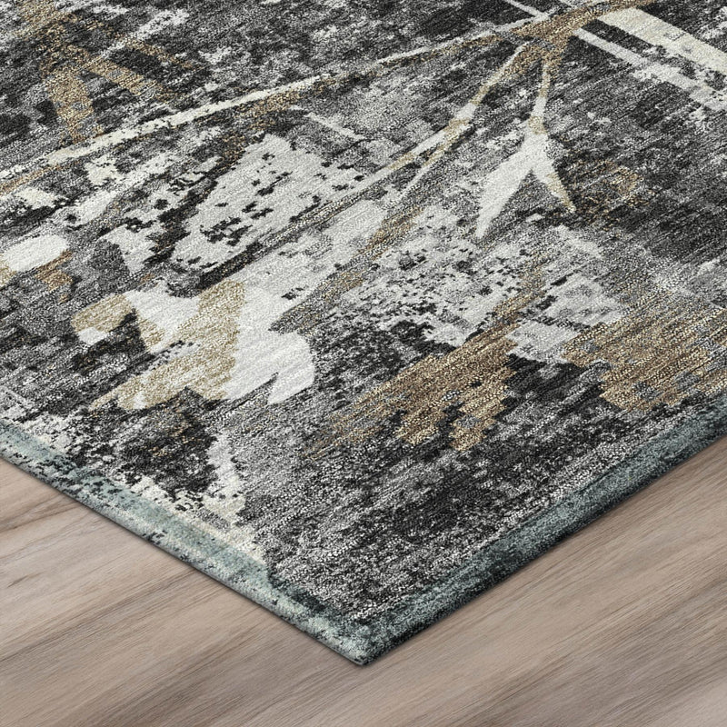 Corner of black-and-graphite area rug with ivory and gold distressed floral design