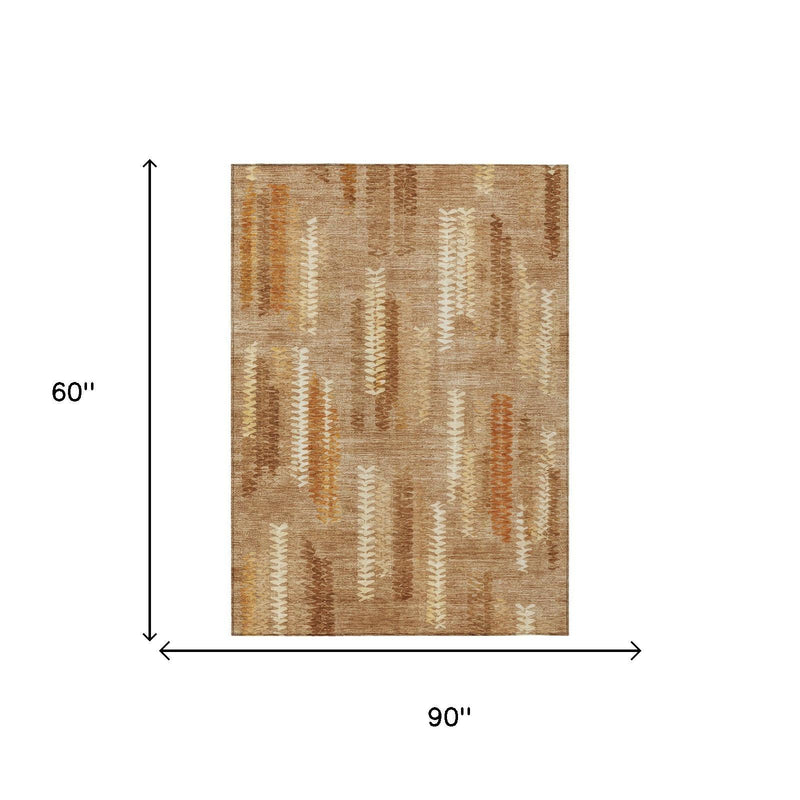 5 ft by 8 ft abstract area rug in tan with copper and orange accents