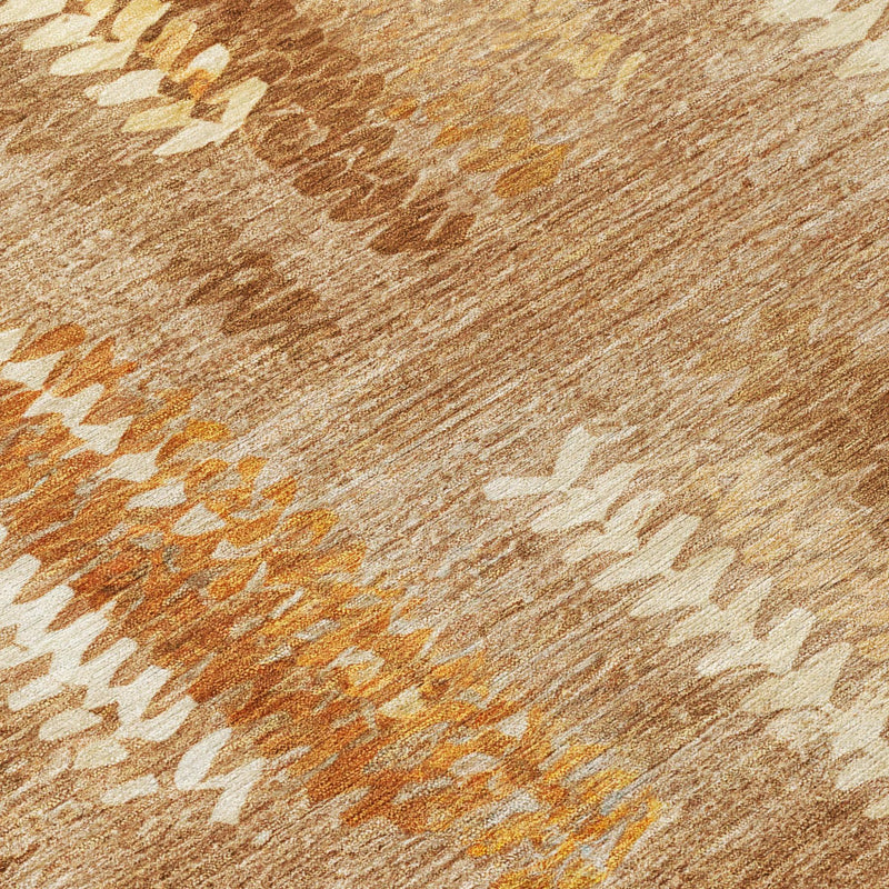 Close-up of tan abstract area rug with orange and white zigzag motif