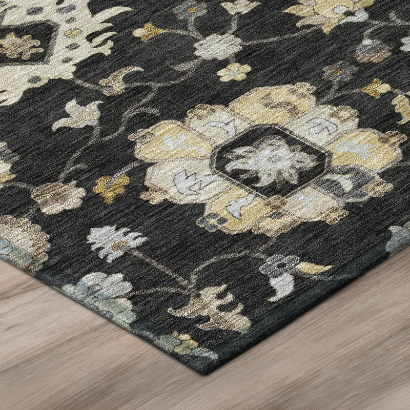 Black area rug corner showing floral vine pattern with medallion detail