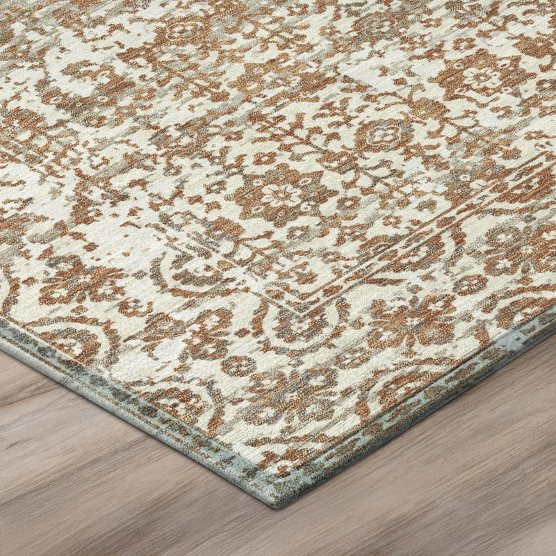Corner view of cream, ivory and warm brown abstract rug with distressed motif