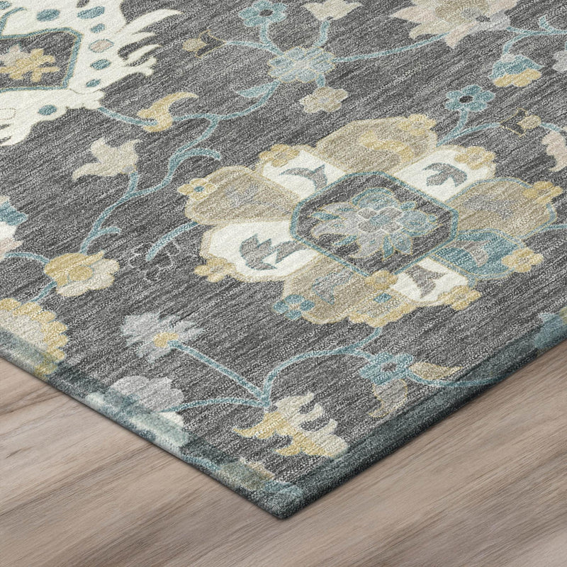 Corner of gray rug showing floral pattern with blue and cream accents