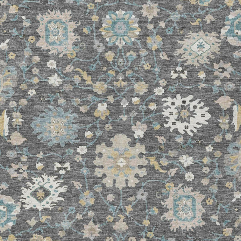 Close-up of gray rug with repeating floral motifs in light blue and cream