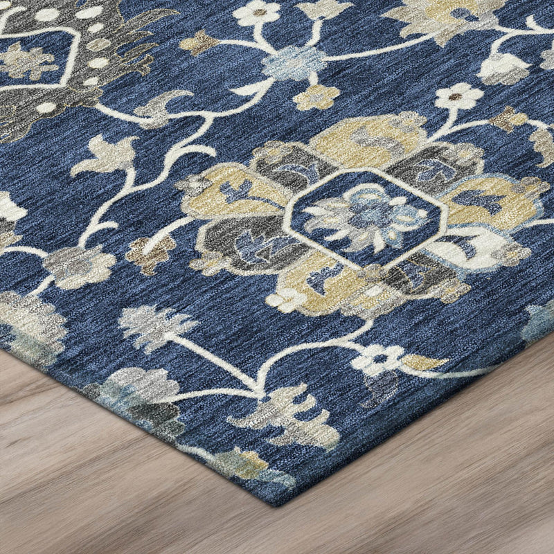 Blue floral area rug corner with navy ground, cream and gold medallions and vines