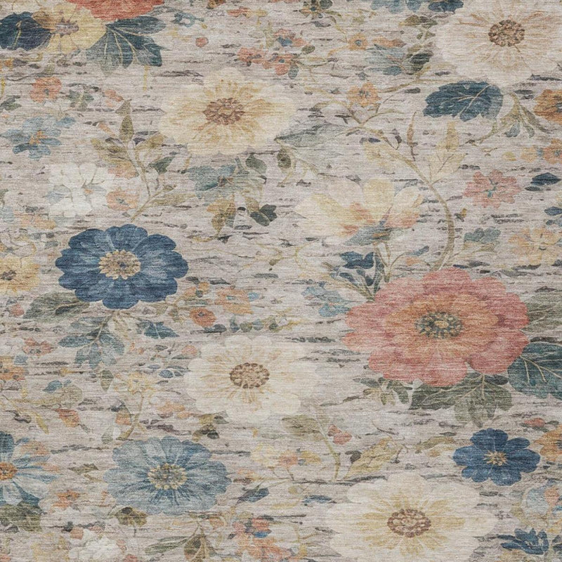 Close-up ivory floral area rug with blue and coral flowers and vine-like details