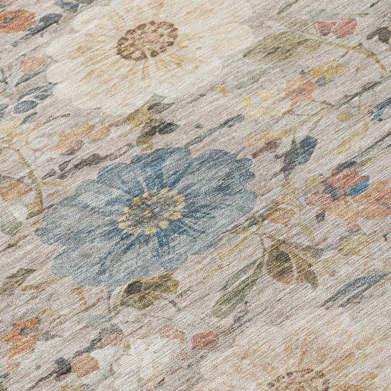 Distressed ivory area rug with blue floral motif, tan accents, and textured weave