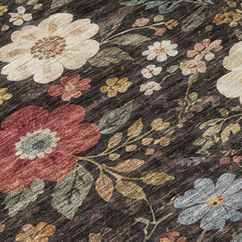 Close-up floral area rug on dark charcoal background with beige and red blossoms.