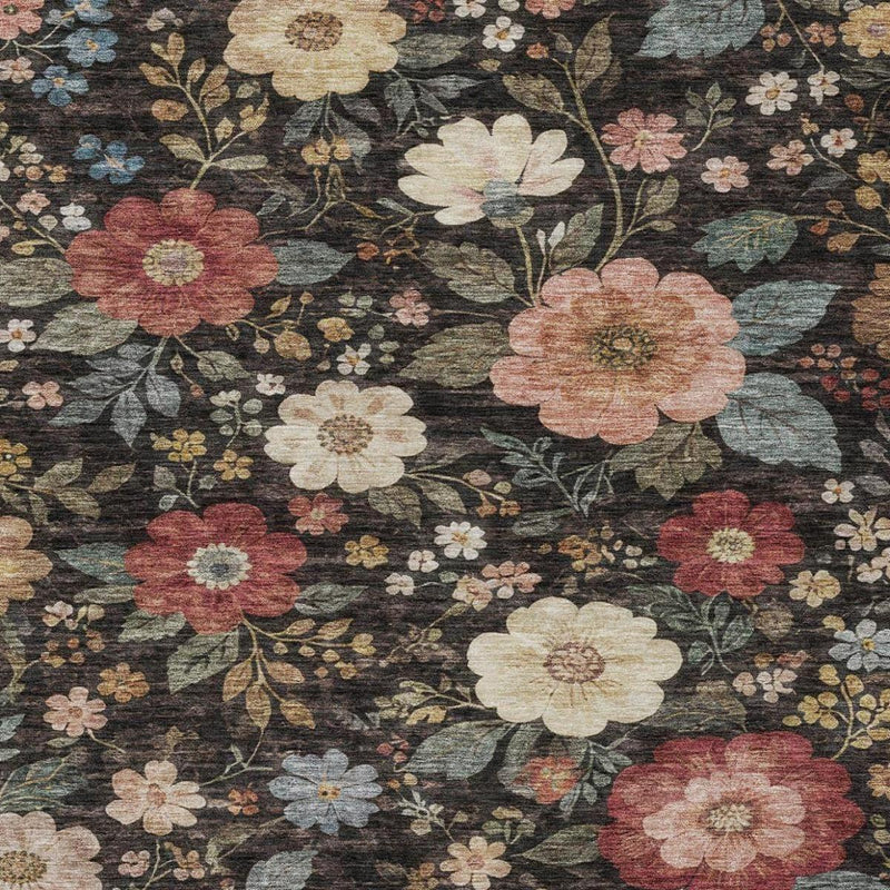 Floral area rug in dark charcoal with cream, coral, and blue flower details.