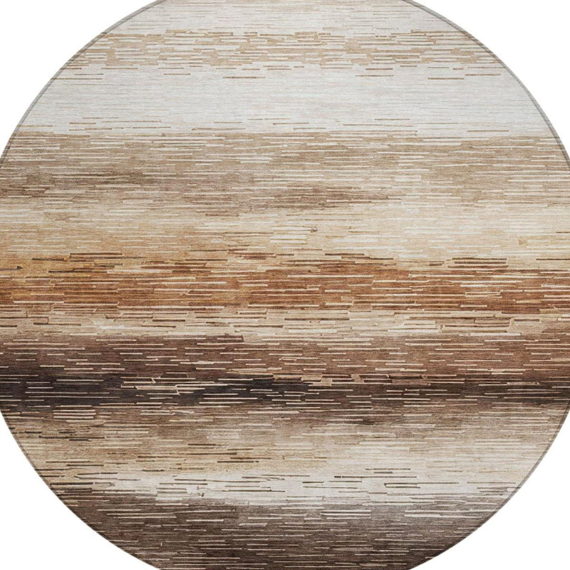Detailed view of round area rug stripes in beige, brown, and dark silver