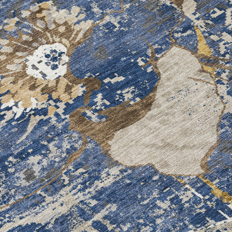 Corner close-up of navy, cream, and tan abstract floral wash indoor/outdoor rug