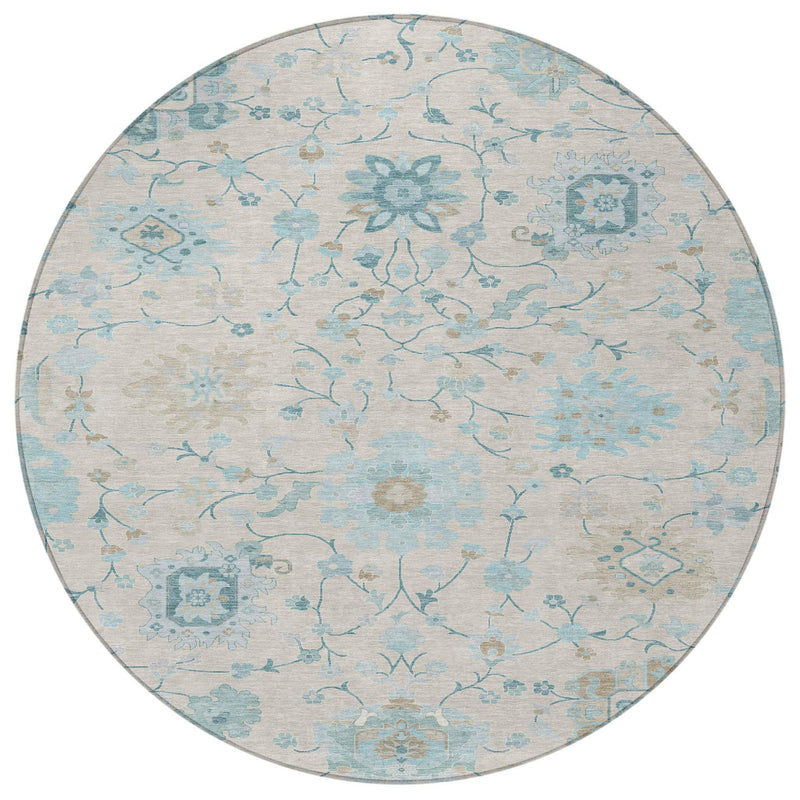 Round rug with light ivory background and blue floral medallion and vine pattern