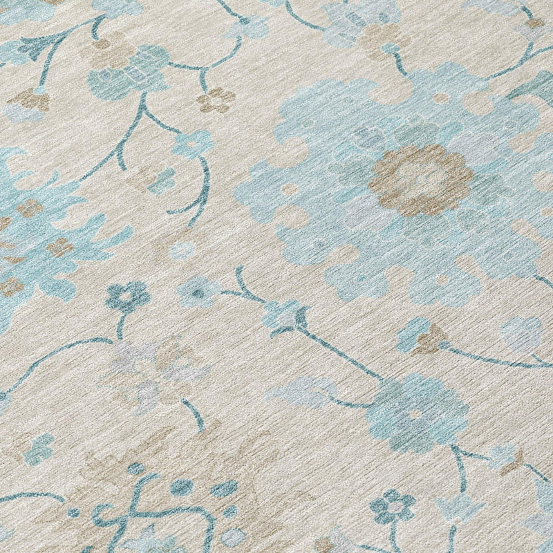Close-up of blue floral vine pattern on light ivory round area rug with textured weave
