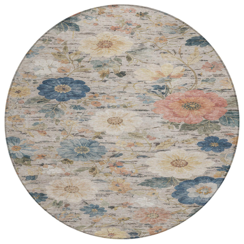 Round floral rug with ivory base and scattered blue and peach flower motifs