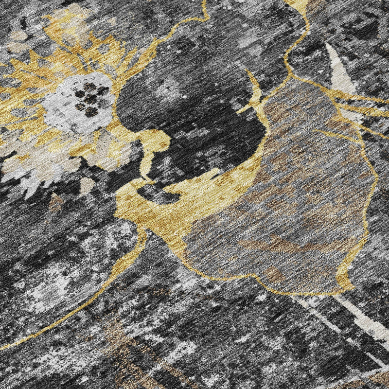 Close-up abstract rug surface with charcoal, white, and yellow-gold floral details