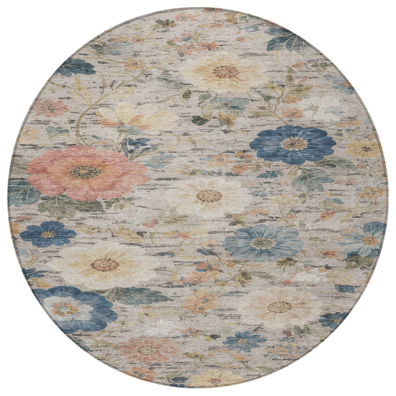Round floral area rug with ivory background, blue and peach blossoms, and leafy vines