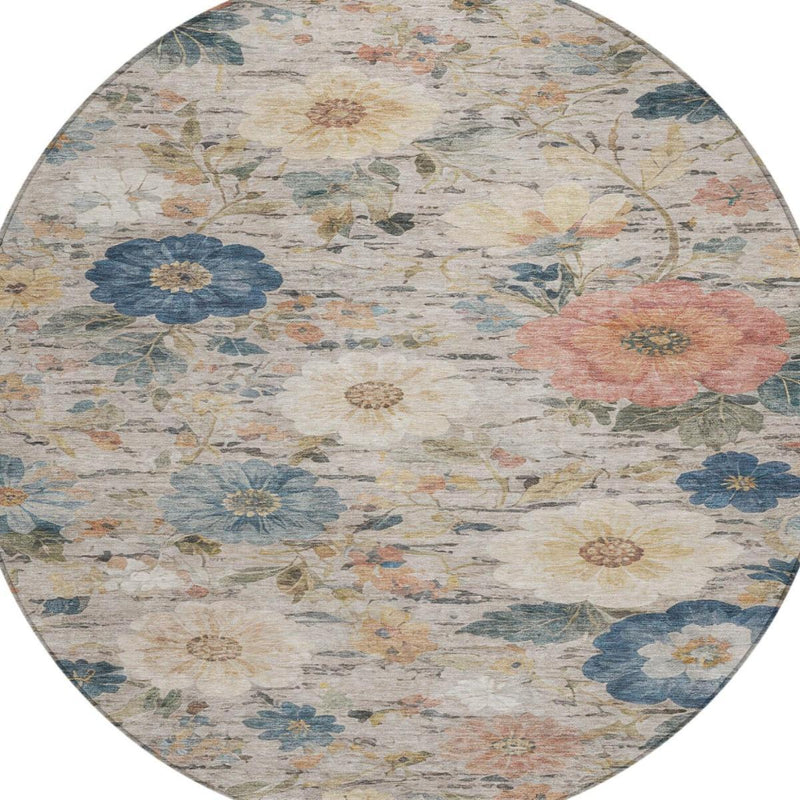 Close view of round floral rug with blue and pink flowers on an ivory ground