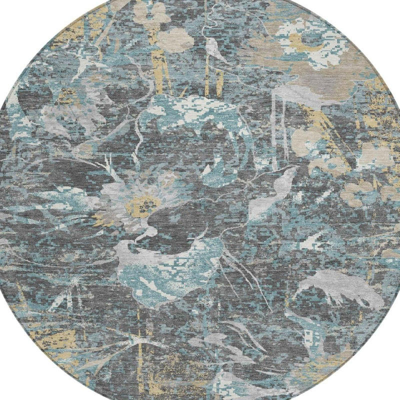 Round rug with layered abstract floral shapes in gray, light blue, and tan accents