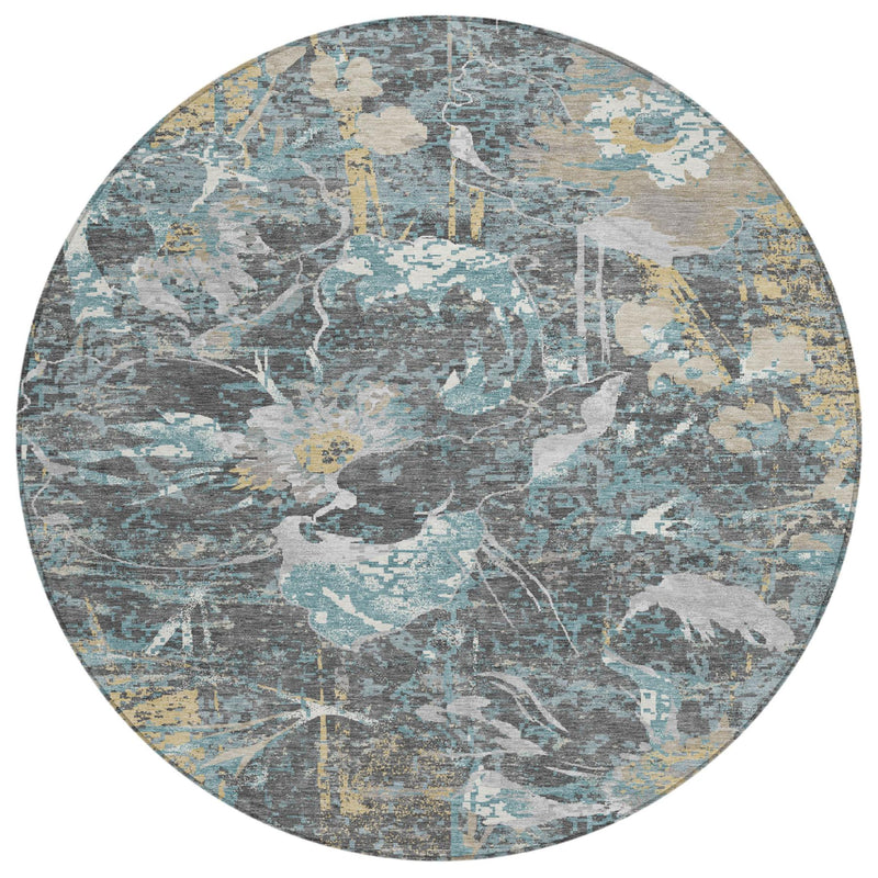 Round area rug featuring distressed floral medallion pattern in gray, blue, and mustard