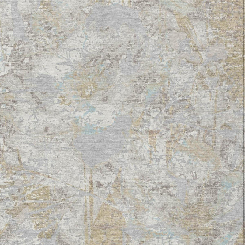 Close-up of ivory and silver area rug with abstract floral motifs and speckling.