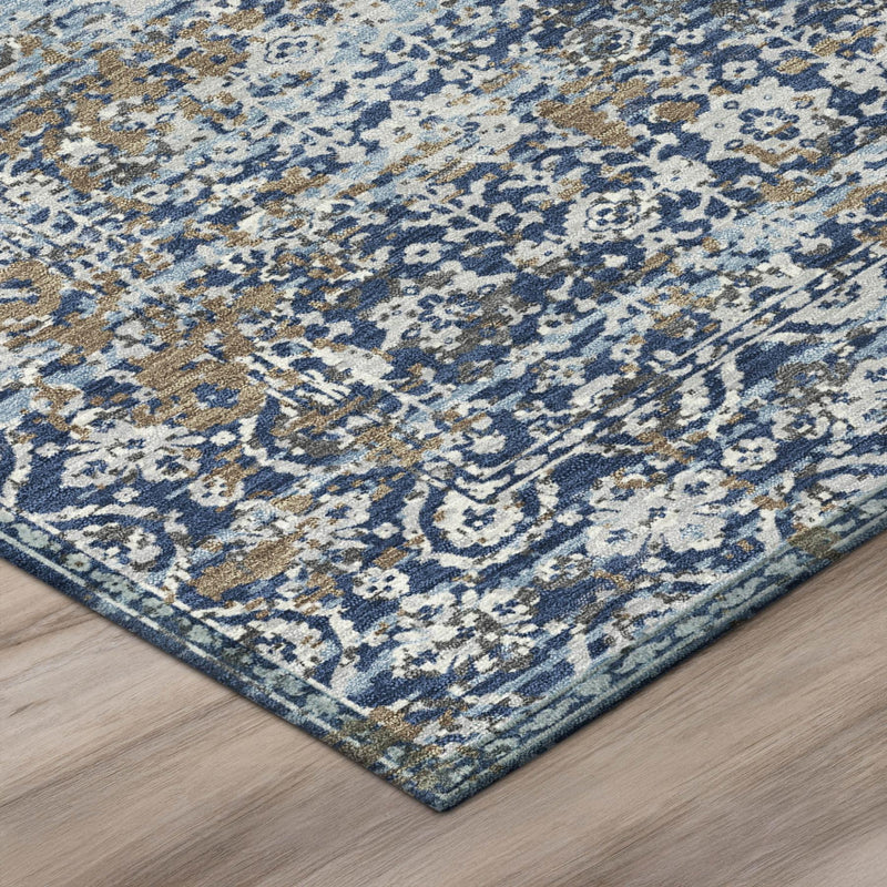 Corner detail of navy and blue abstract area rug with distressed border and texture