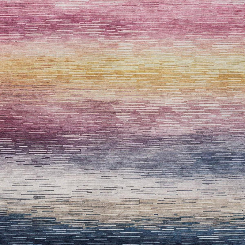 Washable striped area rug close-up with pink top bands fading to gray-blue