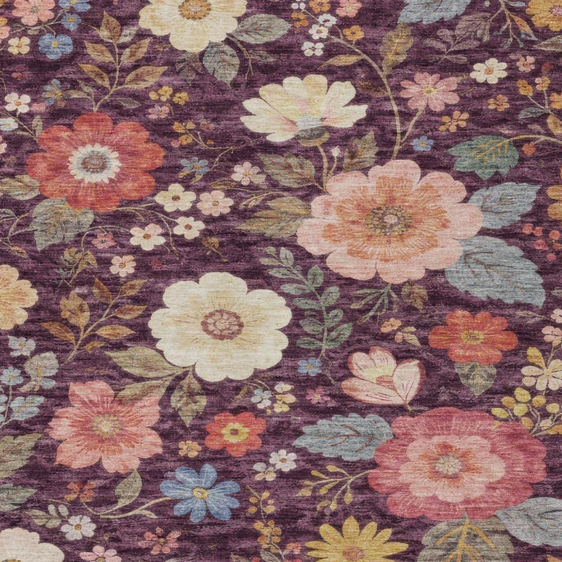 Close-up of plum purple floral rug pattern with cream, peach, and blue flowers