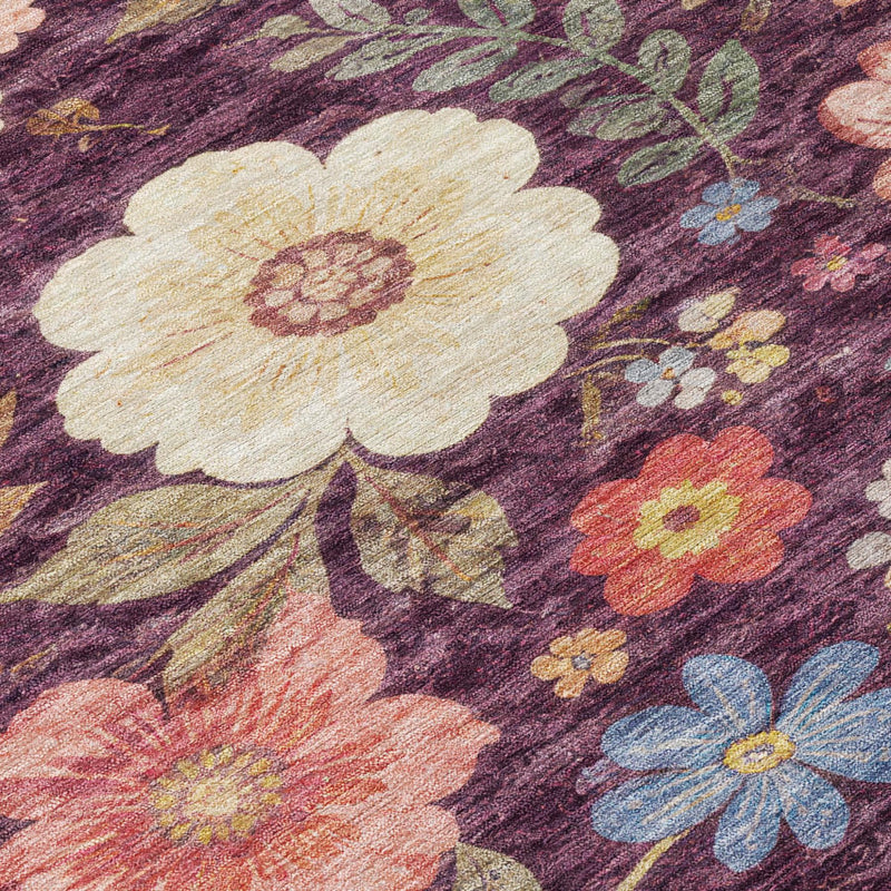 Floral rug close-up: large cream flower with peach accents on plum purple ground