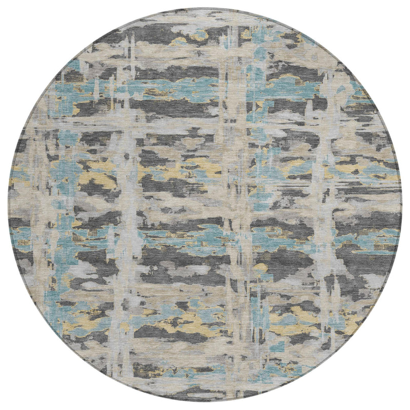 Round abstract area rug with gray, cream, and light blue patchwork grid pattern
