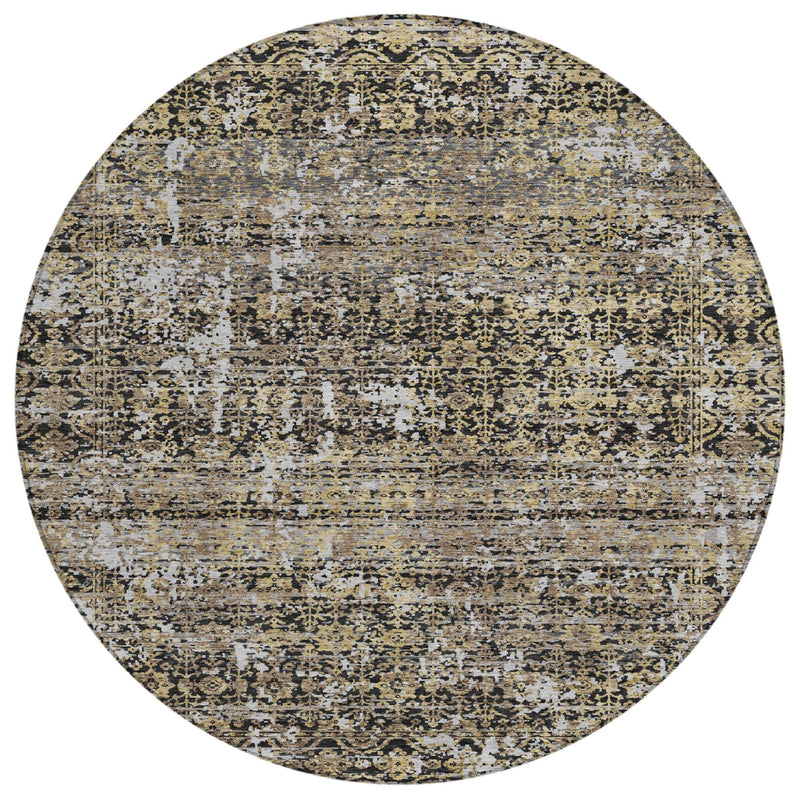 Round abstract area rug with ornate speckle in cream, muted yellow, and dark tones