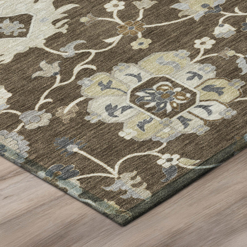 Edge/corner of floral area rug in dark brown with cream and muted blue pattern