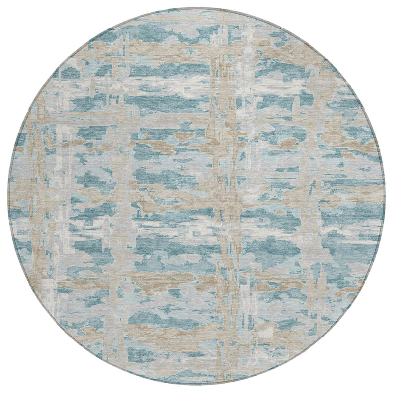 Round area rug top view with light blue, teal, and beige layered abstract block pattern