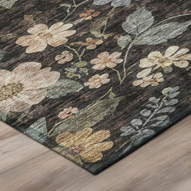 Corner view of black and gray floral area rug with cream and muted multicolor blooms.