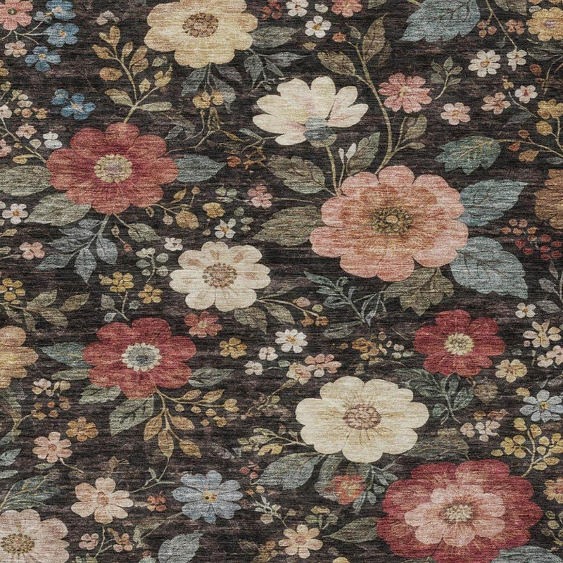 Black and charcoal floral area rug with layered cream, red, and blue flower clusters.