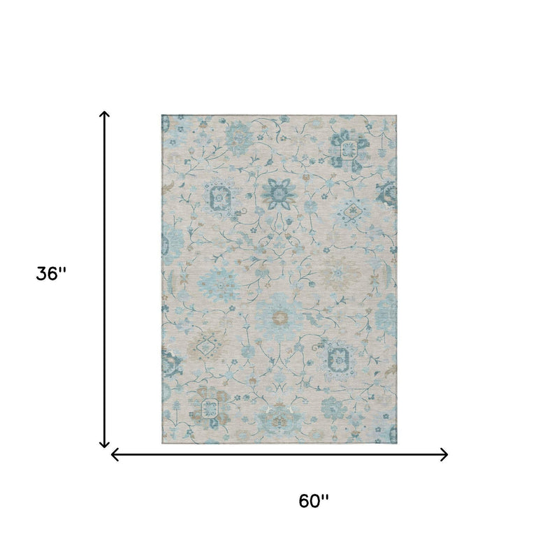 Light blue and ivory floral area rug, rectangular design with distressed pattern