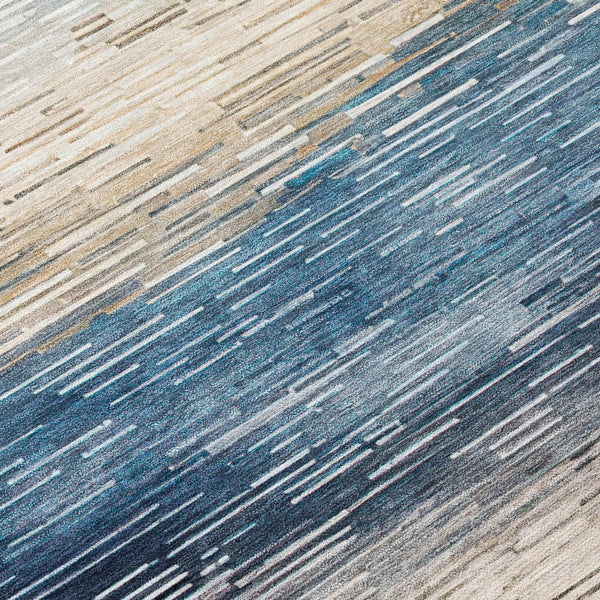 Textured close-up of rug stripes in blue, cream, and dark gray