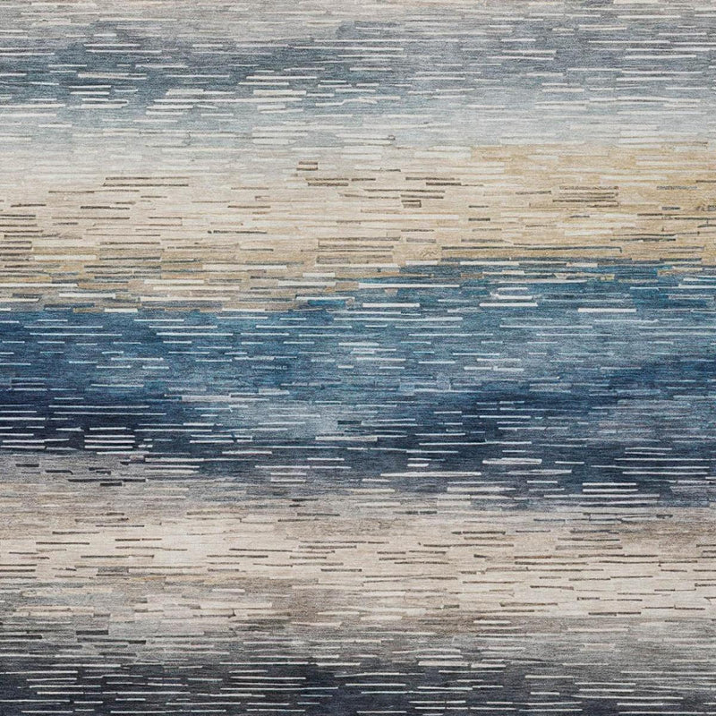 Abstract striped area rug detail with blue and cream bands and gray texture