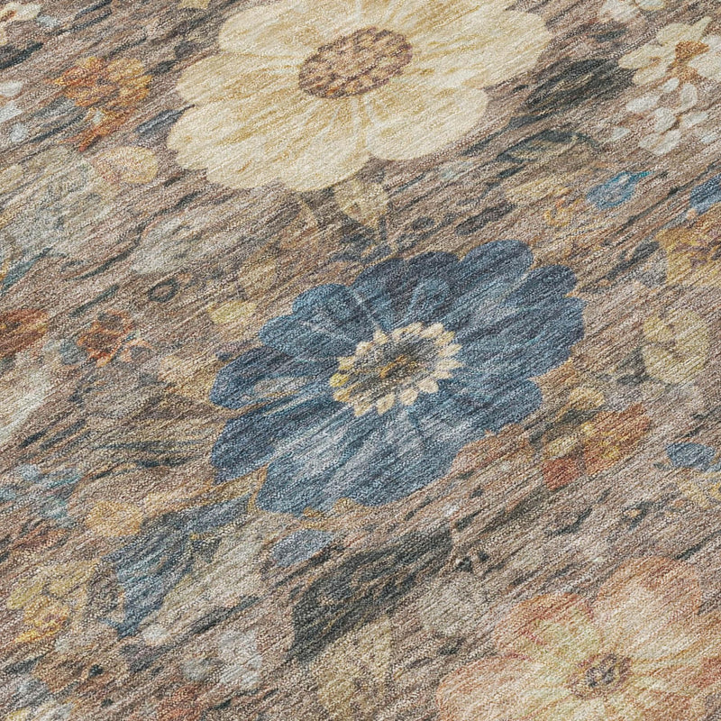 Distressed floral rug close-up with blue blossoms on beige-brown ground.