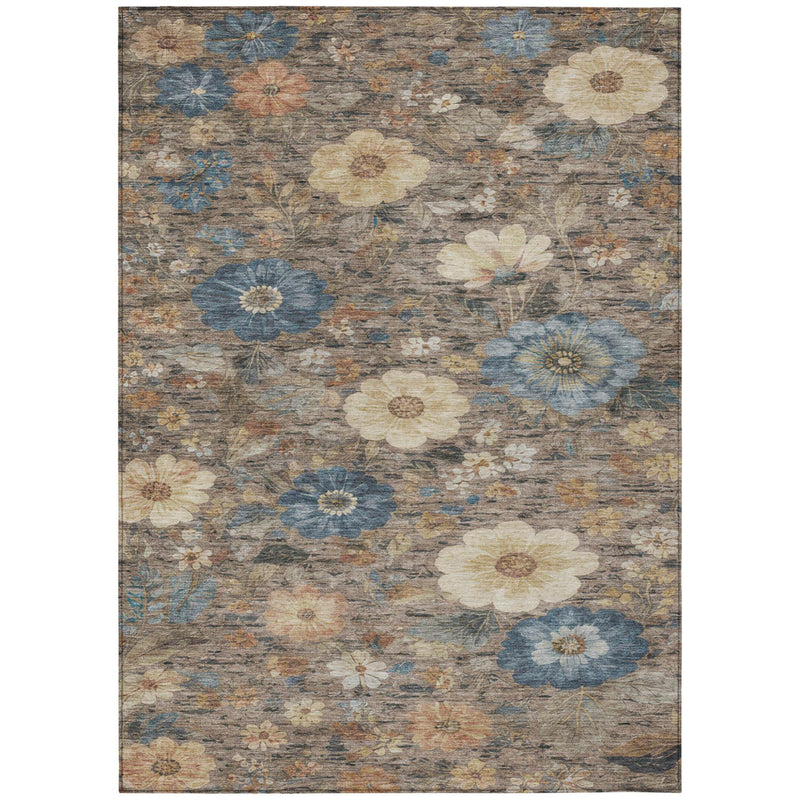 Rectangular distressed floral rug in tan, brown, and muted blue with layered blossoms.