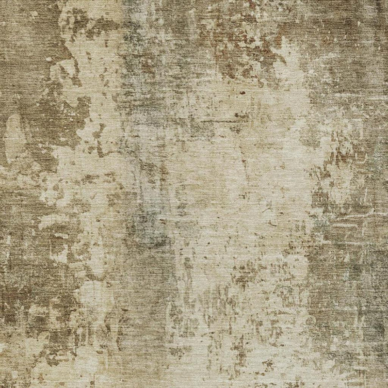 Beige and olive abstract wash area rug with distressed mottled pattern close-up